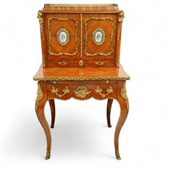 Late 19th century French Louis XV style kingwood and ormolu mounted bonheur du jour, the upper section with a pierced three-quarter gallery over a pair of cupboard doors inset with Sèvres-style porcelain portrait plaques, enclosing a shelved interior over two short drawers, the serpentine top and apron richly mounted with gilt-bronze foliate and scroll motifs, single frieze drawer below on cabriole supports with acanthus cast sabots