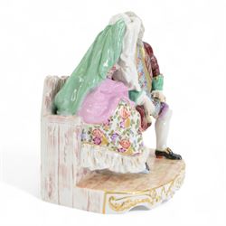 Late 19th/early 20th century Samson Paris porcelain figure group, modelled as a male and female figure seated upon a bench, with underglaze blue cross mark beneath, H25cm W24cm 