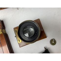 Ensign 'The Sanderson' folding plate camera in mahogany and lacquered brass, field model with canvas wrapped box, two mahogany photographic plates, 'Busch rapid Symmetrical F:8' lens,  and a wooden tripod 