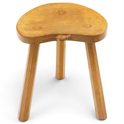 Mouseman - oak three-legged milking stool, dished kidney-shaped seat, raised on three octa...