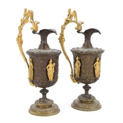 Pair of bronzed and gilt ewers in the Neo-Classical taste, each of typical form with figur...