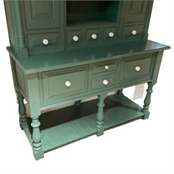 Large contemporary teal green painted kitchen dresser, projecting cornice over three open shelves flanked by cupboard with five spice drawers below, the base fitted with four assorted drawers, raised on turned vasiform supports united by undertier