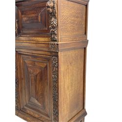 Late 17th century Flemish/Dutch rosewood and oak ‘Zeeuwse Kast’ or cupboard, projecting cornice carved with three putti masks, the uprights carved with lion masks over ribbons, flower heads and foliage, enclosed by four geometric panelled doors, lower central upright carved with flower head over foliate ribbon with bird among foliage, the escutcheon hidden by swivel berry carved cover, interior fitted with shelves, two drawers and shallow hinged cupboard, on two large turned and ebonised feet, circa 1680