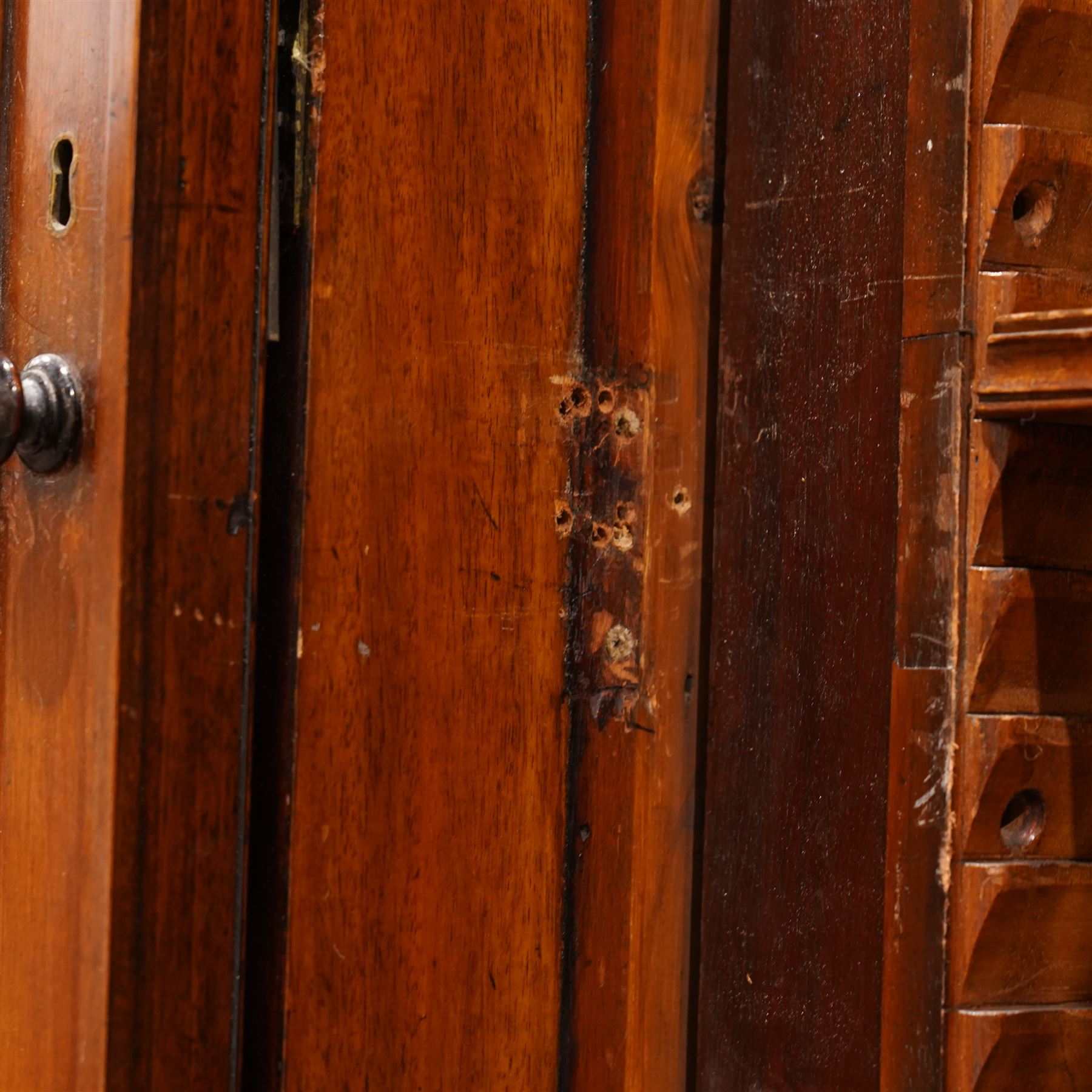 Large Georgian mahogany library bookcase, projecting moulded cornice with row of globular mounts, adjustable shelving enclosed by six astragal glazed doors, fitted with two slides and six panelled cupboard doors, two banks of five drawers, on moulded plinth base; together with two pairs of associated astragal glazed doors in mahogany, from the same property (W55.5cm x H168cm & W48cm x 168cm)