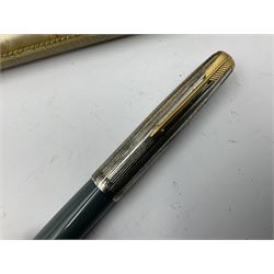 Three parker fountain pens, one example with 14ct gold plated cap and personal engraving, in Parker 51 box, together with a silver Sampson Mordan Everpoint propelling pencil with personal engraving and a silver cased fountain pen with 14ct gold nib and a souvenir bronze Dollfus-Mieg medallion, awarded to John G Sedorski, in fitted case 