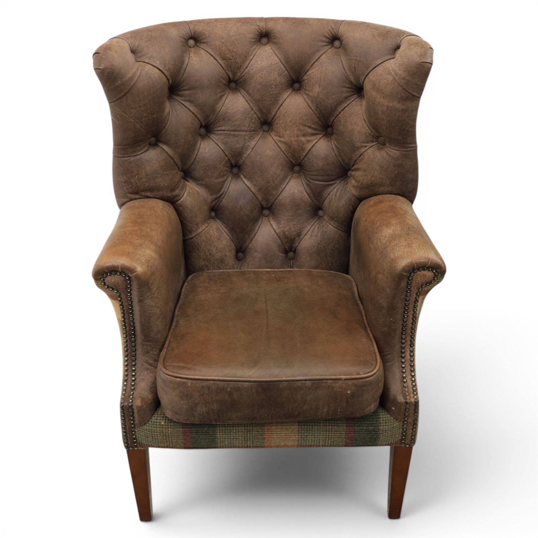 Pair of Georgian design wingback armchairs upholstered in brown leather and tartan tweed fabric, button back and scrolled arms with brass studded trim, square tapered supports