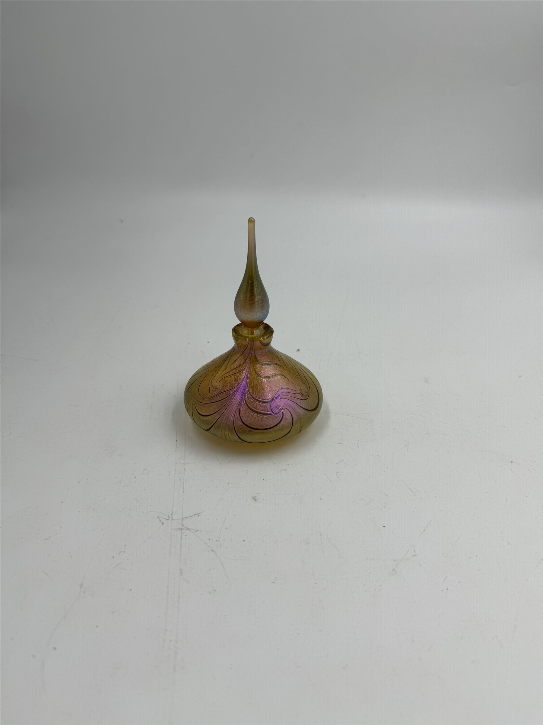 Three Okra scent bottles, each decorated with iridescent patterns on a pink ground, including perfume apple, all with original boxes, from Richard P Golding Studio 