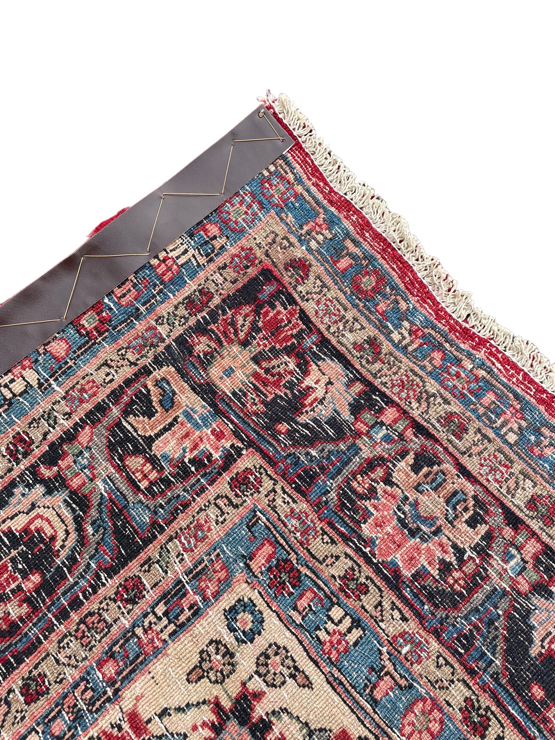 North West Persian Bidjar red ground carpet, shaped pole medallion surrounded by interlacing branches and stylised flower heads, five band border with repeating floral design