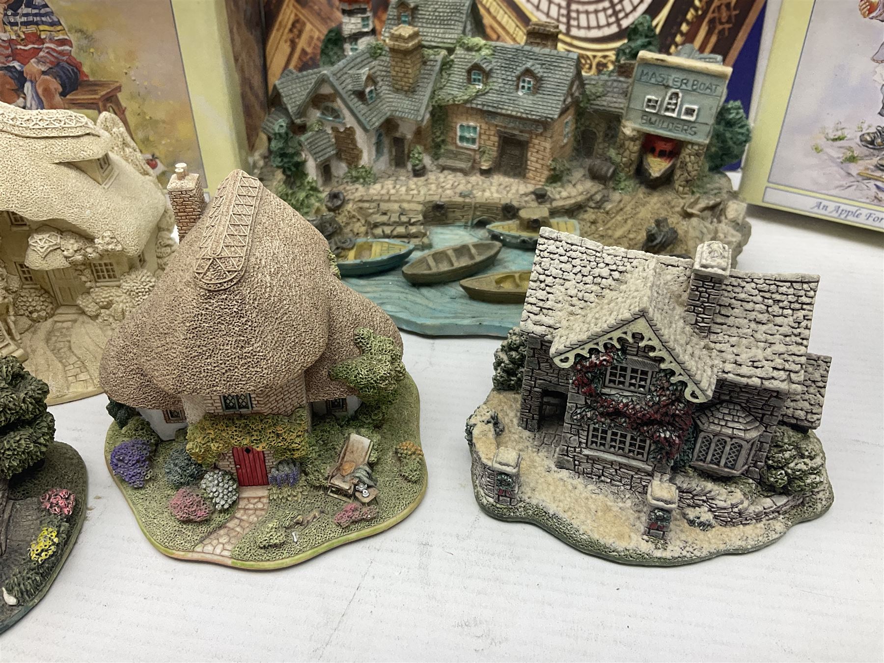 Twenty three Lilliput Lanes, including Village School, Lace's Shoe Shop, Cockles & Muscles, Scotland the Brave etc, together with The Leonardo Collection Paint Box Poppets and Gullivers World magazines 