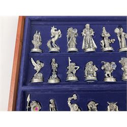 Danbury Mint 'The Fantasy of the Crystal' chess set consisting of mythical pewter chess pieces within a wooden case with chess board lid, together with 16 additional chess pieces in a wooden display case.