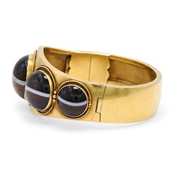 Victorian gold banded agate hinged bangle, set with five graduating cabochon cut agates, surrounded by wirework and bead decoration