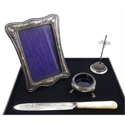 Silver hat pin cushion stand, three leaf clover design by James Deakin & Sons, Chester 1919, mother of pearl knife with silver blade by Barker Brothers, Chester 1922, George III silver salt by James Tookey, London and a silver photograph frame hallmarked (4)