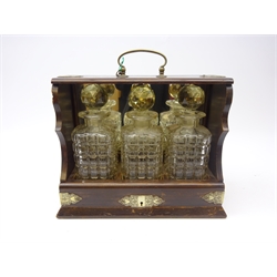  Victorian oak three bottle tantalus with sliding drawer action, mirrored back with silver-plated mounts and handle, L35cm  
