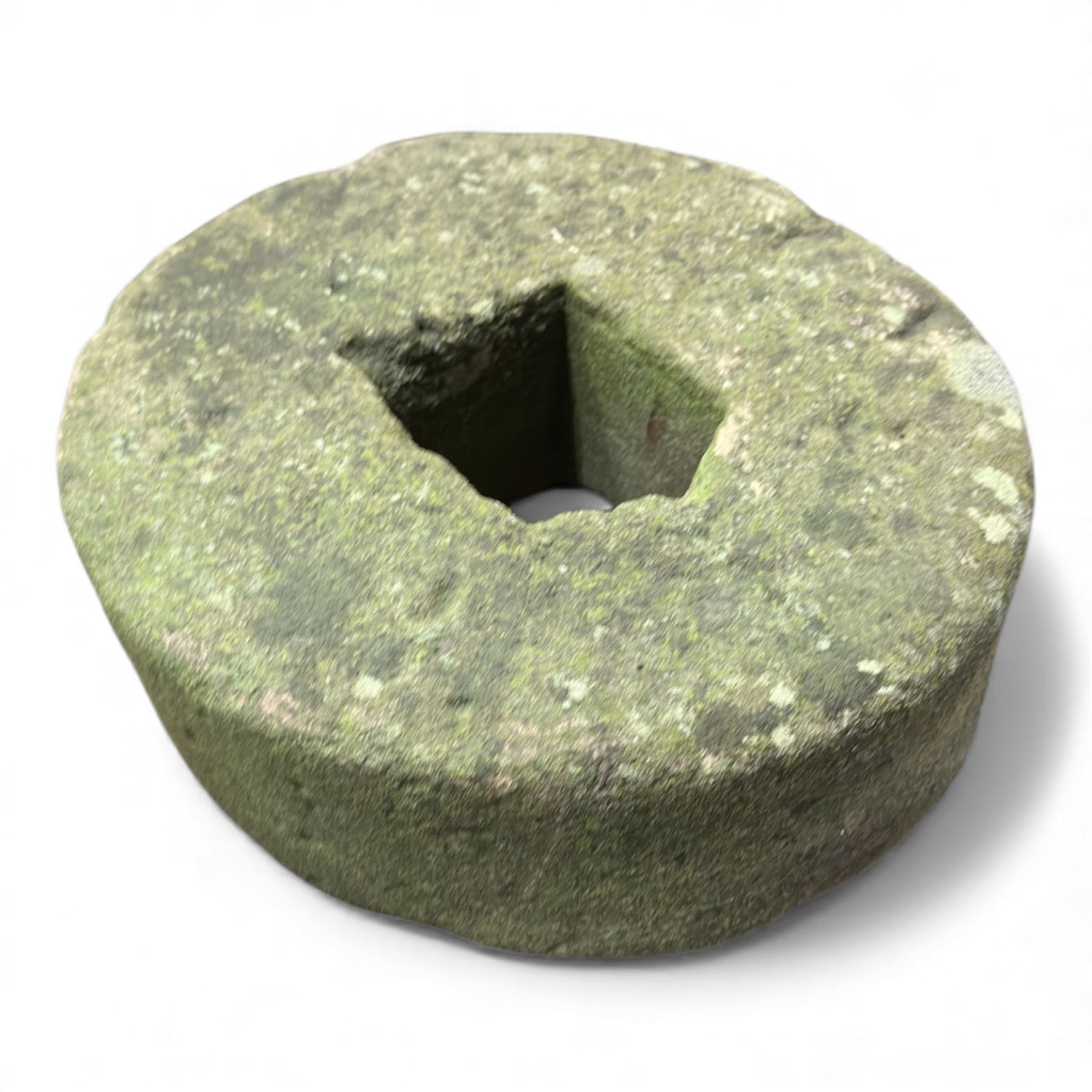 Collection of cast stone garden objects including mill stone, trough, planter, and faces