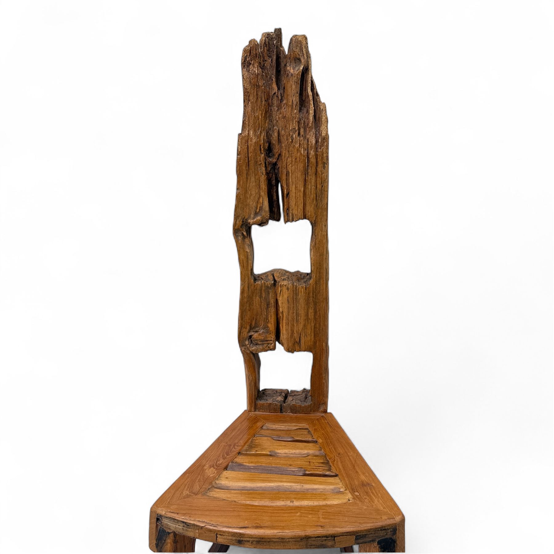 20th century driftwood sculptural hall chair, solid triangular seat over shaped apron, high ladder back formed from weathered and irregular timber, raised on curved legs united by H-stretcher