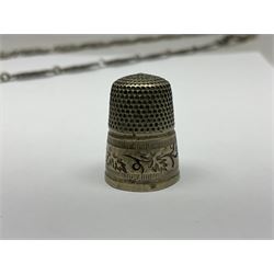 19th century continental silver plated chatelaine, the main body flanked with winged mythical beasts and central soldier slaying a dragon supporting three suspended items to include velvet lined small basket and long clasped filigree chain, together with a thimble