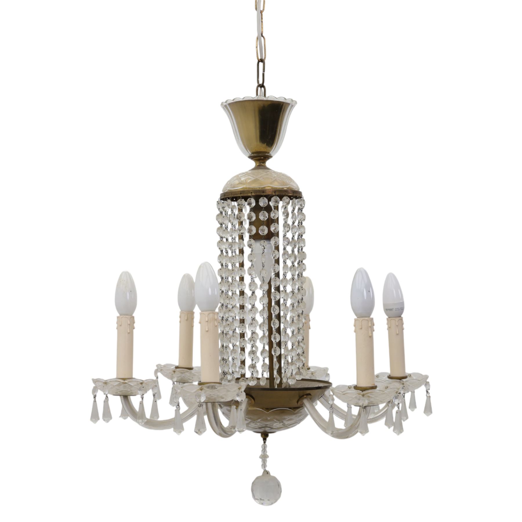 Early 20th century Continental glass and brass six branch chandelier, the central baluster column hung with graduated faceted glass drops, issuing six scrolling glass arms each fitted with candle sconces and drip pans, suspended from a fluted glass canopy