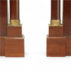 Rare pair of French Second-Empire neoclassical style mahogany mirrors with ormolu mounts, architectural pediment with central ormolu patera above flame mahogany frieze with honeysuckle flower and caryatid mounts, the frame with ormolu beading and bevelled mirror plates, flanked by turned columns with ormolu mounts above a reverse breakfront base, circa 1870