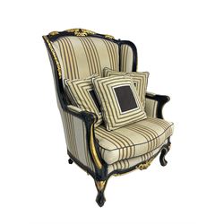 Thomas Messel - Georgian style ebonised and gilt wingback armchair, upholstered in striped fabric, on cabriole front feet