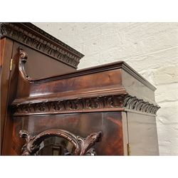 Large Georgian style mahogany breakfront bookcase, sloped pediment carved with foliage, the top section enclosed by astragal bevel glazed doors, the lower section enclosed by three cupboard doors decorated trailing flower head and cartouche mounts, on plinth base 