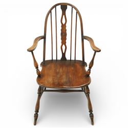 Early 20th century Windsor armchair, the arched hoop back enclosing a pierced and shaped splat flanked by turned spindles, above a shaped elm seat and outswept arms on turned supports, raised on turned legs united by an H stretcher