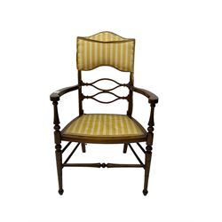 Edwardian inlaid mahogany elbow chair, centre pail pierced and shaped, back and seat upholstered in striped yellow fabric, turned supports