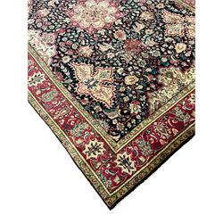 Persian Tabriz rug, blue ground field decorated all-over with trailing branch an floral motifs, repeating scroll border with guards