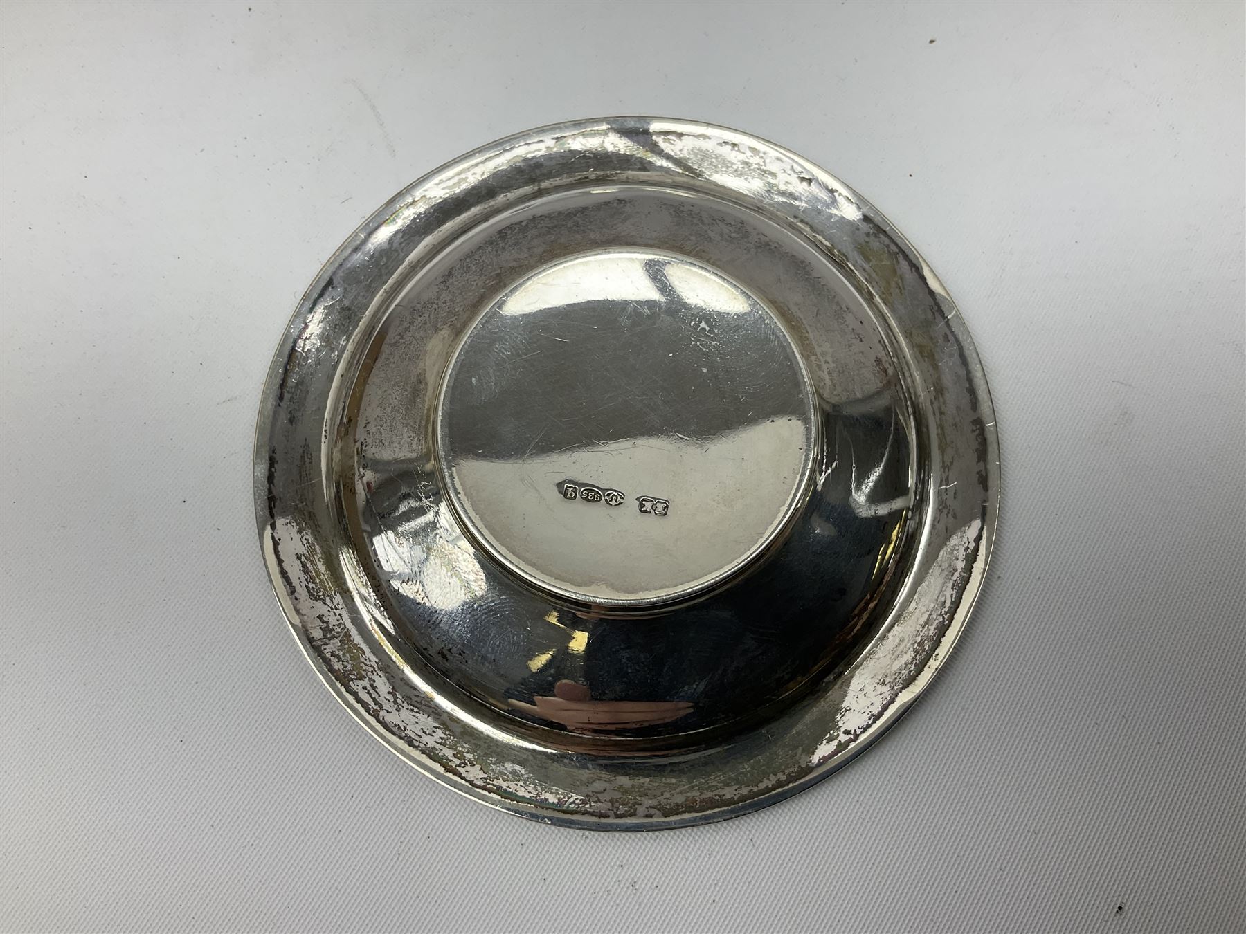 Two small silver page markers in the form of trowels, both hallmarked, together with a small silver and enamel dish, decorated with central panel of flowers, with London import mark, and a small group of flatware, to include Victorian salt spoon, approximate gross weight 111.6 grams