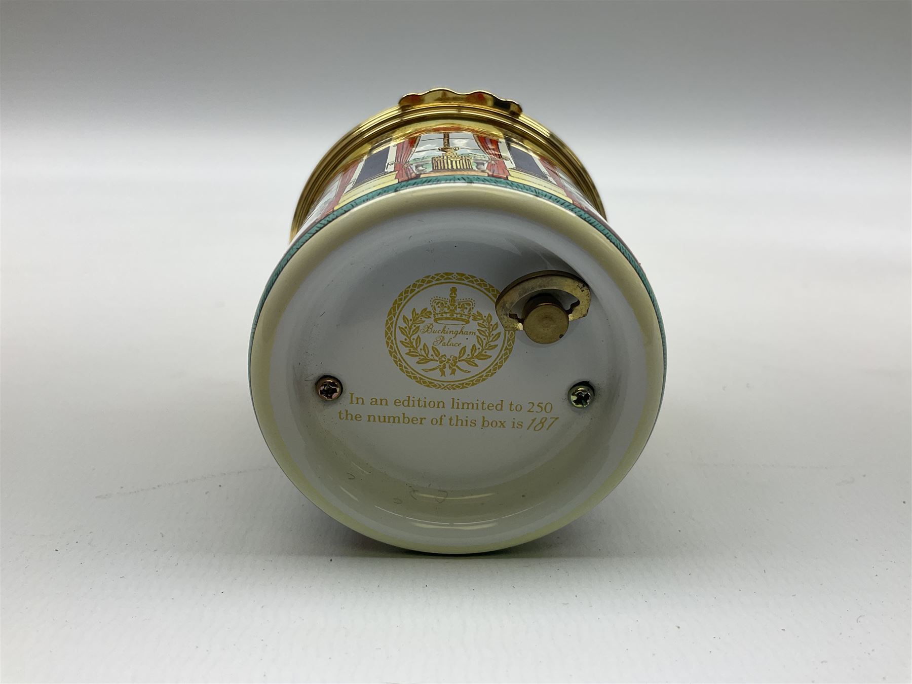Cylindrical music box with domed lid depicting the Music Room at Buckingham Palace and playing Mozart's 'Voi Che Sapete', limited edition 187 of 250, boxed, together with enamel box for the silver jubilee and a victorian paperweight of Scarbrough  