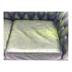 Two seat Chesterfield design sofa bed, upholstered in emerald green leather with deep-buttoned detailing, rolled arms, two loose seat cushions, and pull-out 