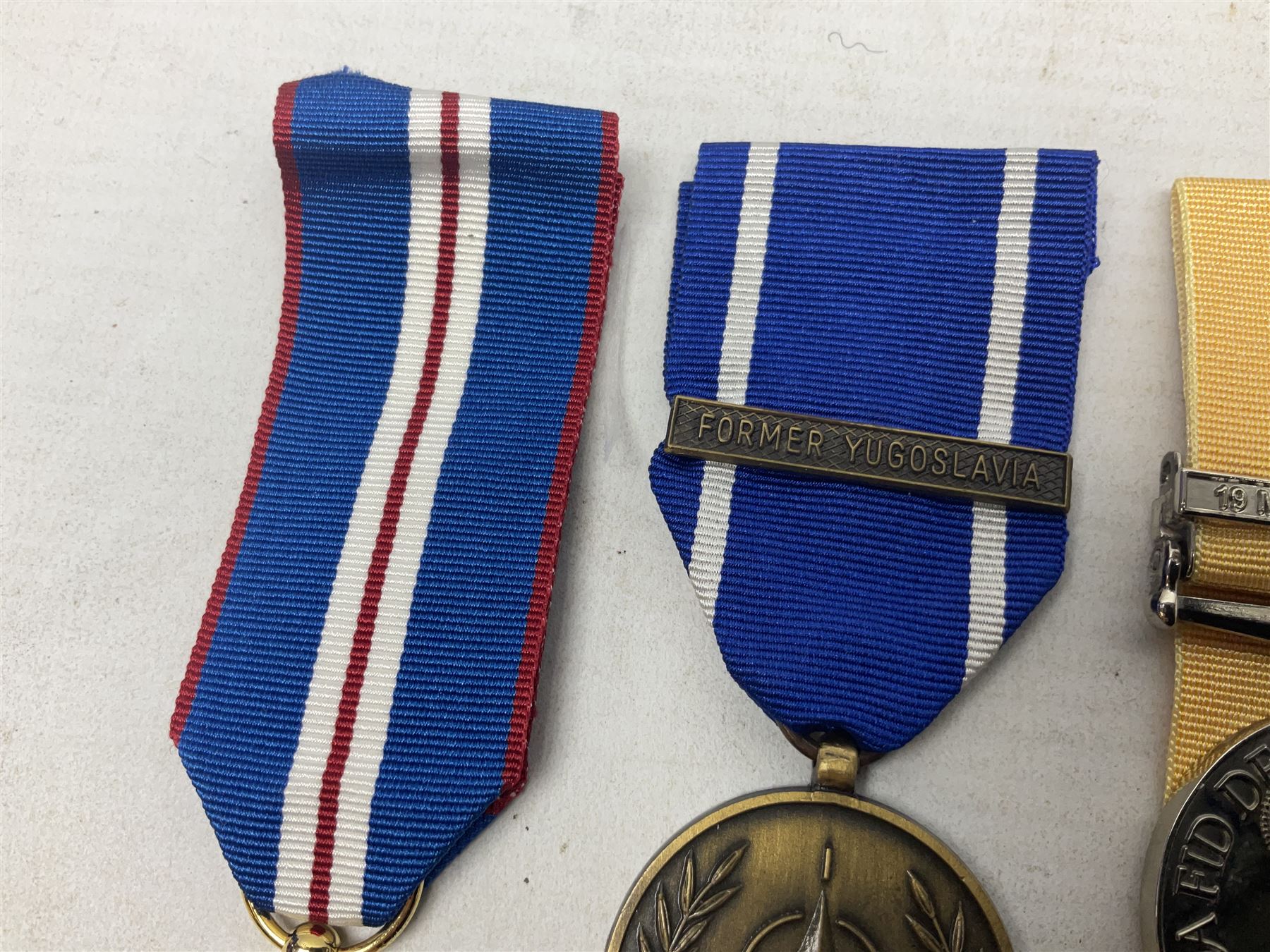 NATO Service Medal with clasp for Former Yugoslavia; together with three copy medals - Iraq Medal with clasp for 19 Mar to 28 Apr 2003 and unfitted rosette; Operational Service Medal with Afghanistan clasp; and QEII Golden Jubilee 2002 medal; all with ribbons (4)