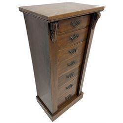 Late Victorian walnut Wellington chest, hinged lock with foliate bracket, fitted with seven graduating drawers, on skirted base