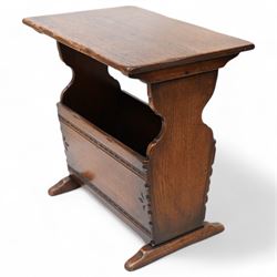 Oak magazine rack or side table, rectangular top on shaped end supports and sledge feet, panelled sides with chip carved decoration 