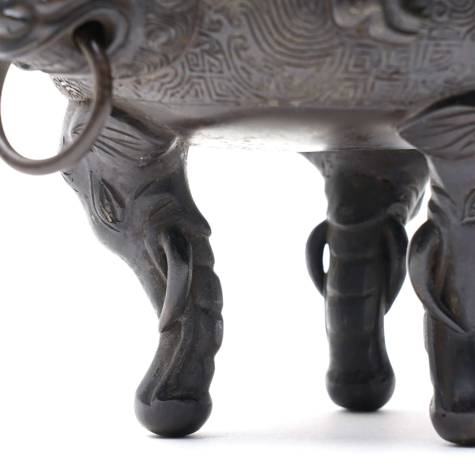 Early 19th century Chinese Qing Dynasty bronze censer, the body of globular form with circular neck and twin cast lion mask ring handles, decorated with applied figures of a monkey, deer and bird, against a key fret detailed ground, the whole upon three zoomorphic elephant feet, H16.4cm D12cm