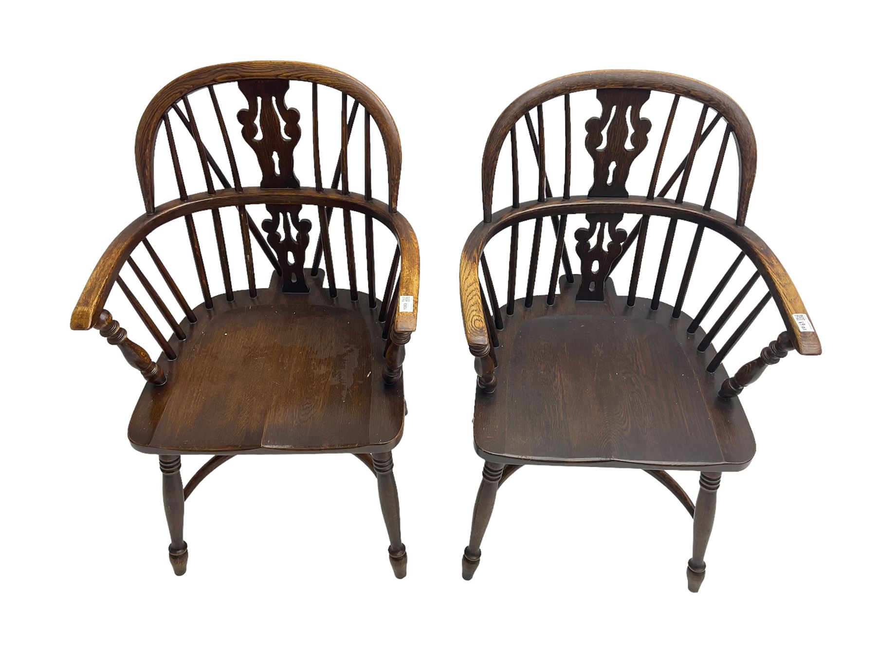 Pair late 20th century oak Windsor elbow chairs, double hoop and stick back with pierced and fretwork work splat, dished seat on turned supports joined by crinoline stretcher
