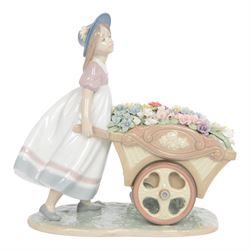 Lladro, Love's tender tokens girl, with floral filled wheelbarrow, model 6521, H23cm