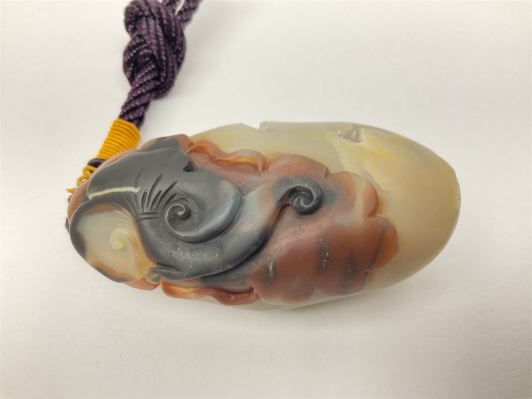 Chinese hardstone carving of a fish amongst coral, with platted rope handle, together with other hardstone and soft stone carvings  