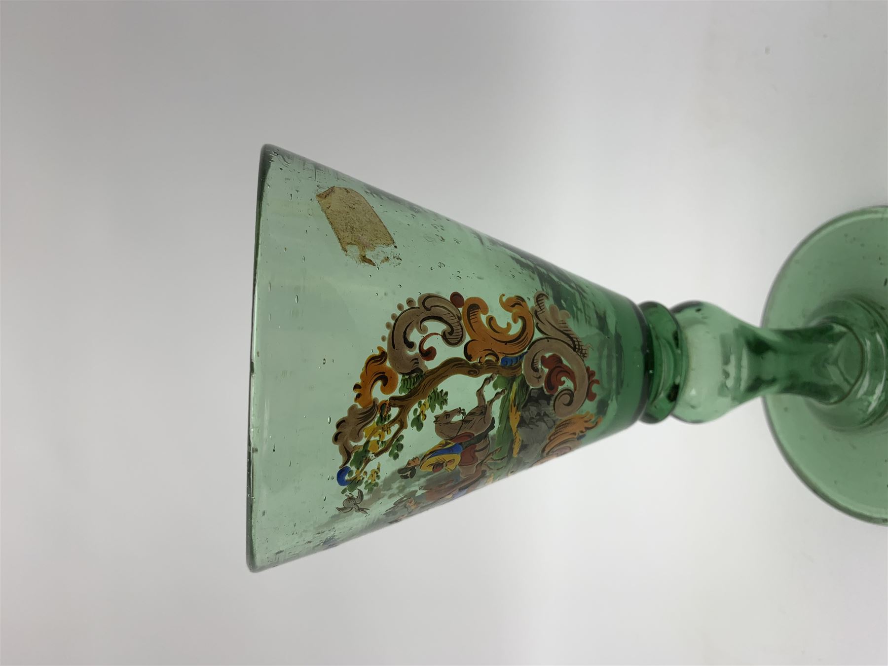 19th century bohemian green glass wine glass, the funnel bowl decorated in enamells with a Historismus hunting scene in the manner of Egermann & Lobmeyr, upon a baluster stem and circular foot, H14.5cm