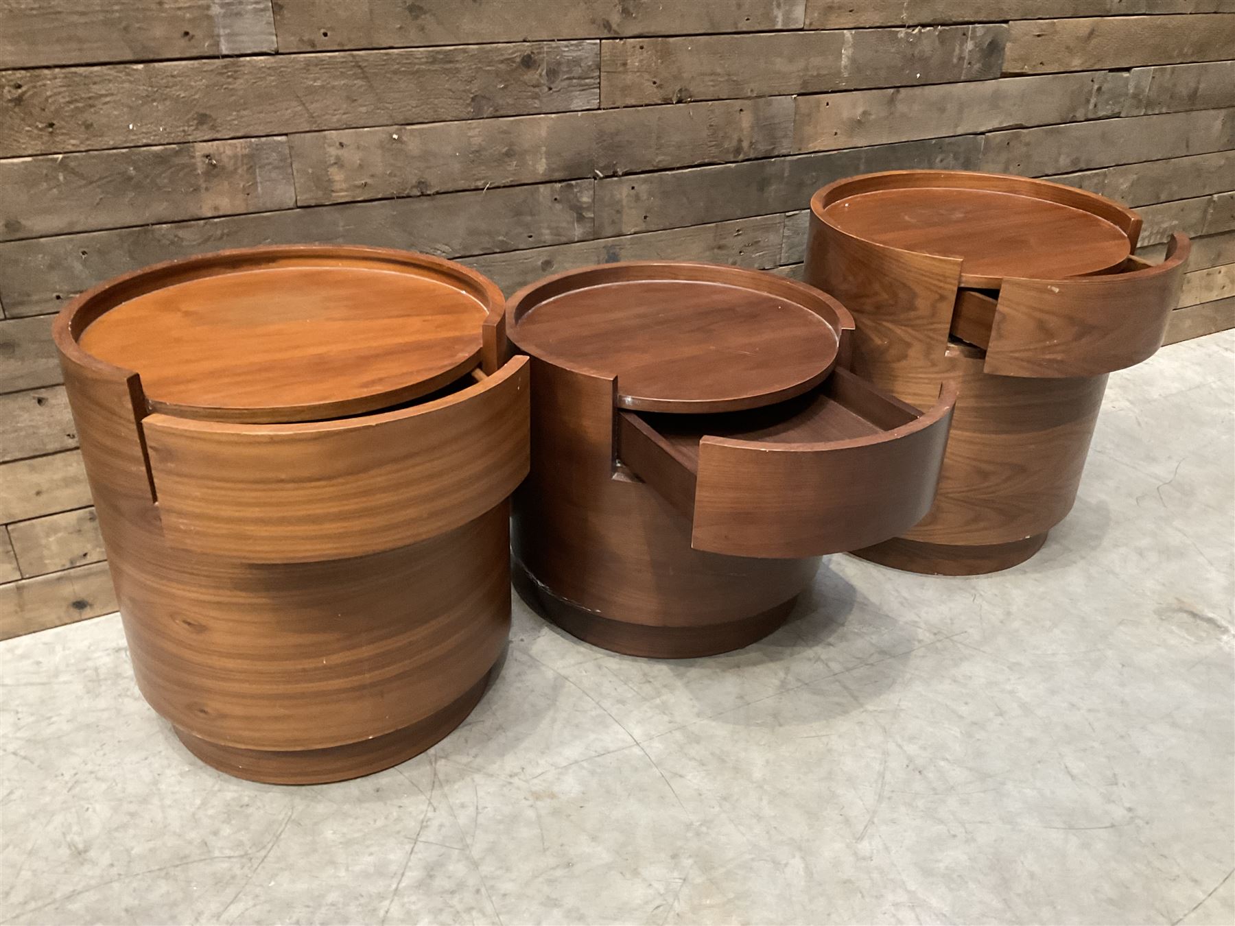 Three walnut circular barrel shaped lamp tables, fitted with single drawer (lower table D53cm, H49cm)