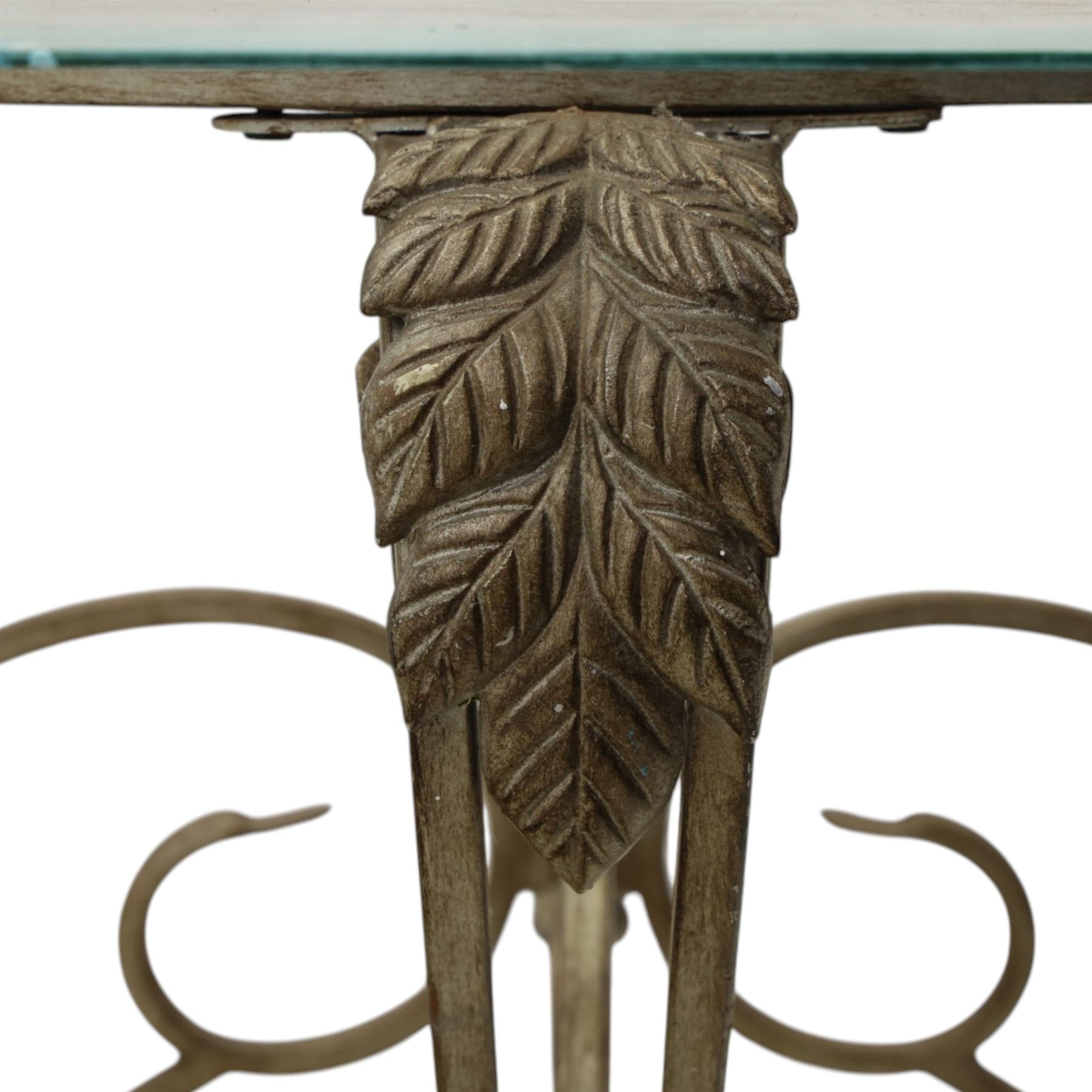 Wrought metal and glass table, with silvered foliate and scrolled design