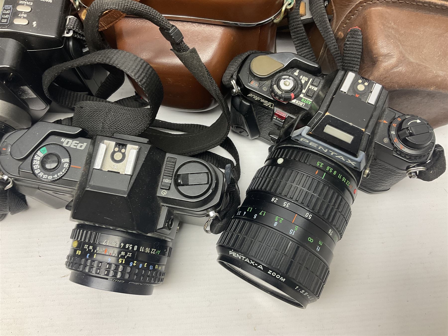 Collection of cameras and lenses, to include Pentax Program A camera body, serial no 123759, with 'Pentax-A zoom 1:3.5-4.5 28-80mm' len, Praktica EE2 camera body with 'Pentacon electric 1.8/50' lens etc, together with a Manfrotto tripod 