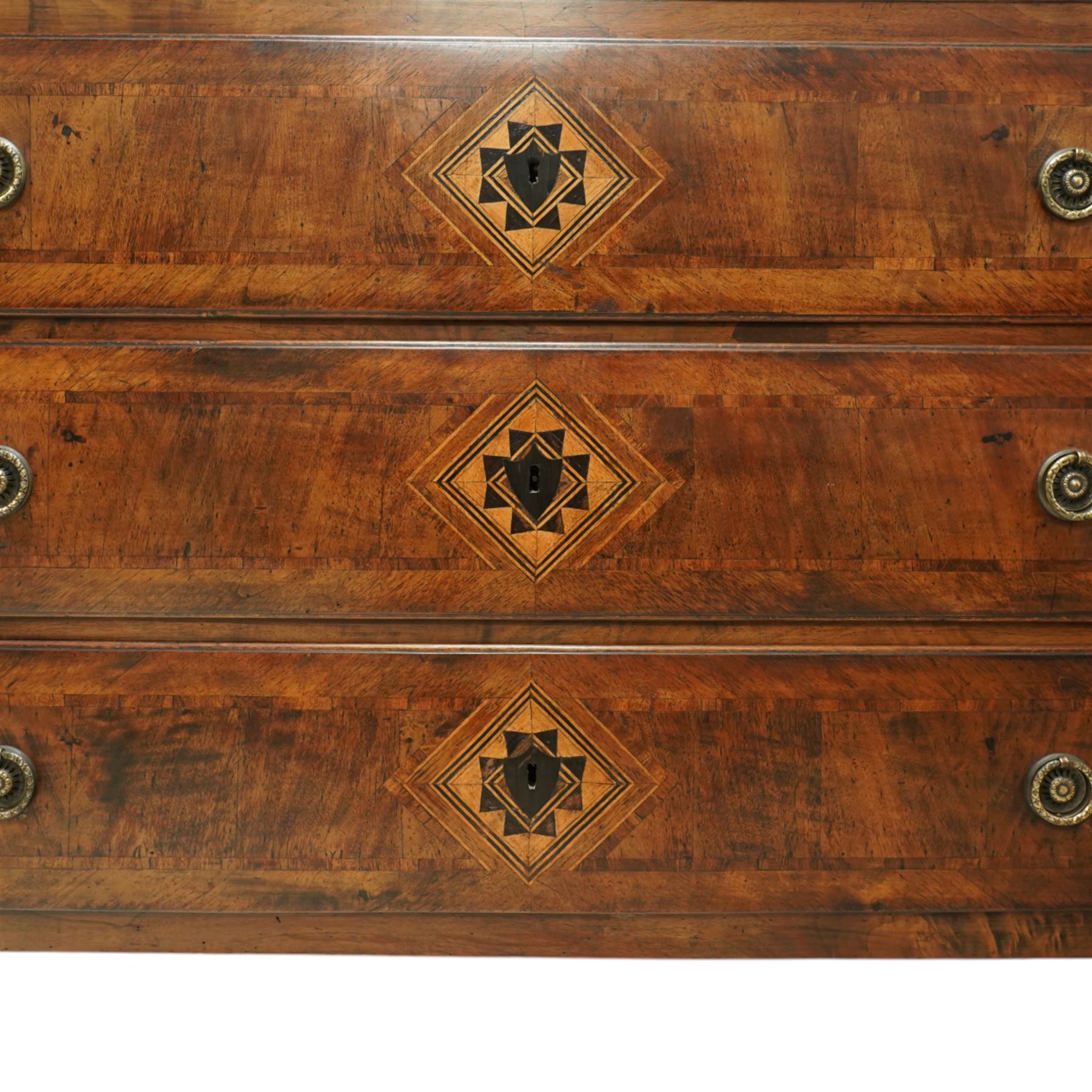 Large 18th-century North Italian walnut commode, rectangular top with quartered veneer, central parquetry inlay and raised moulded edges above three drawers with brass ring handles, cross banding and further central parquetry inlay, supported on square tapered feet
