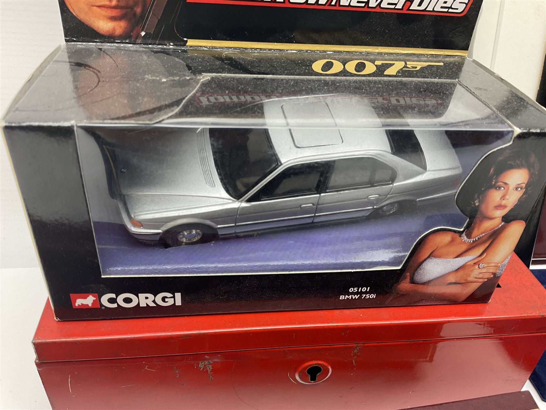 Pierce Brosnan framed picture, James Bond books, Corgi Tomorrow Never Dies BMW 750i model, small number of stamps, empty coin displays and other miscellaneous items