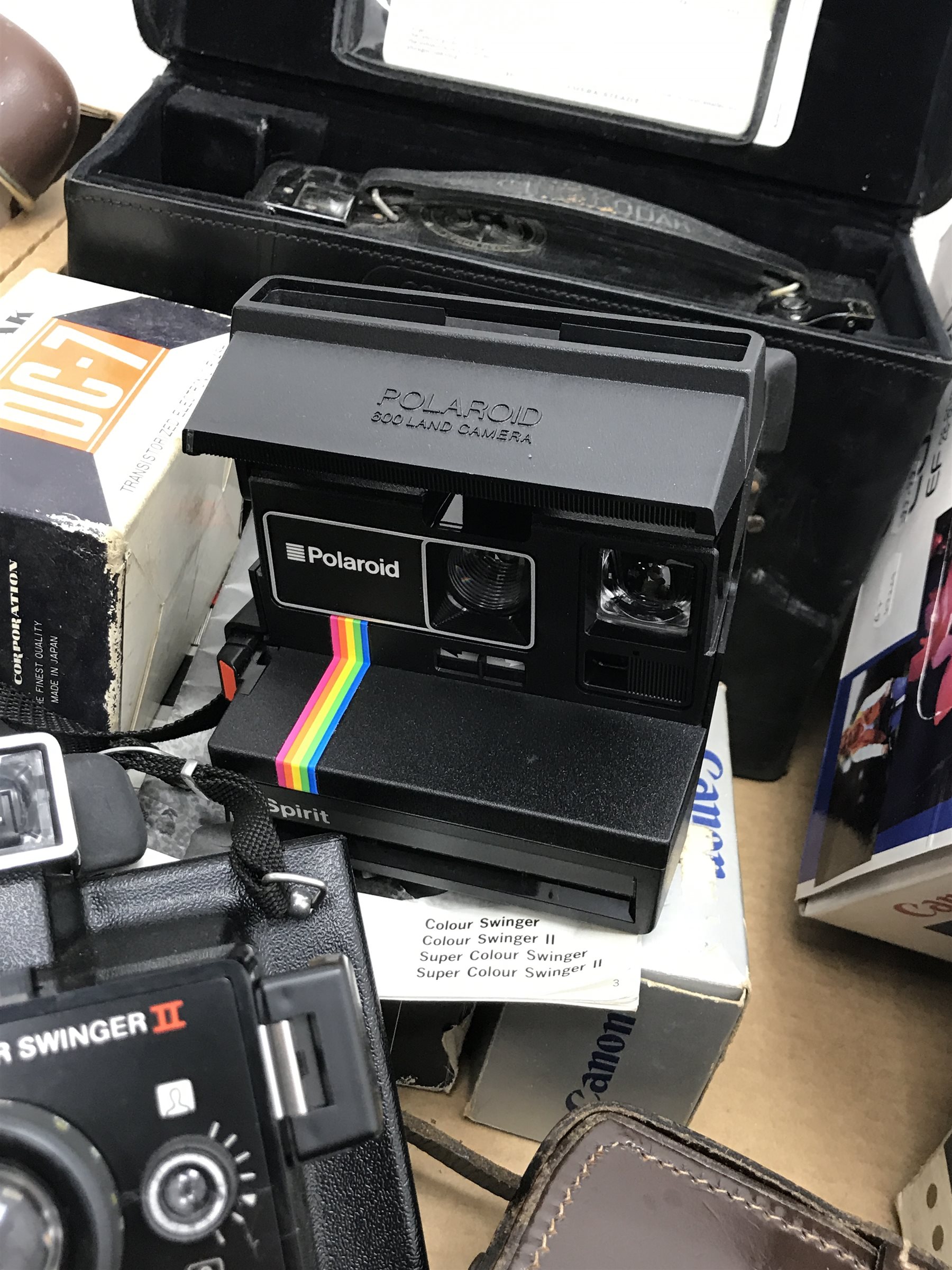 Large quantity of camera equipment in three boxes - Panasonic ZOOM C-900ZM 35mm camera, PENTAX sportmatic camera, RICOH 500 ME camera, Canon EOS 500N camera and lens boxed, Voigtlander VITO CLR camera, MAMIYA 16 camera, KODAK SIX-20 Junior, Minolta RIVA zoom 105i camera, PETRI 7 S camera, KODAK Duo 620 camera, Polaroid 600 Land Camera Spirit, auto teleplus 2x converter, Prinzflex auto 1:2.8, CANON zoom lens 80-200mm, various other cameras, lenses and cases