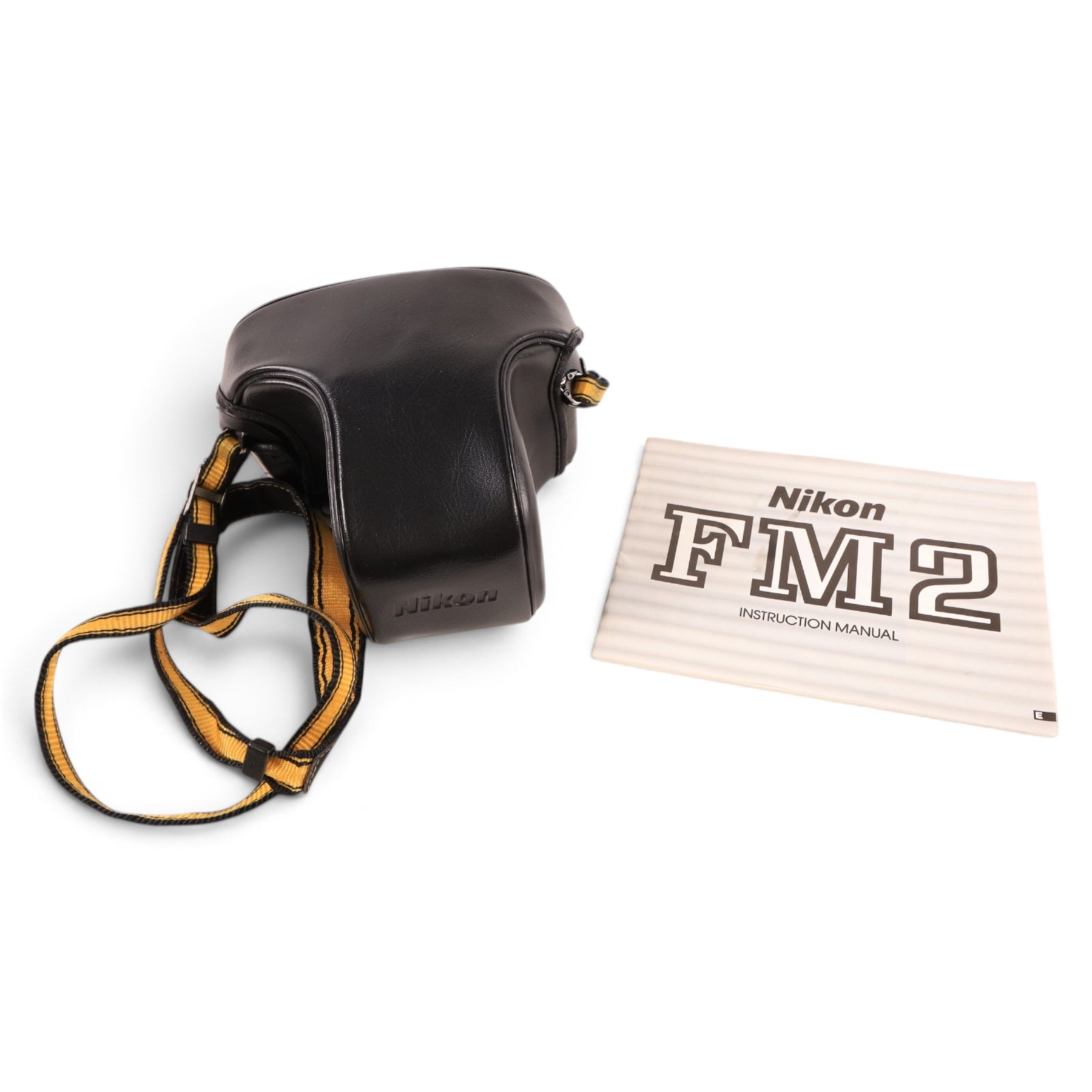 Nikon FM2 film camera body serial no. 7814849 with a Sigma 24mm lens serial no.5083190, camera user manual and Nikon carrying case