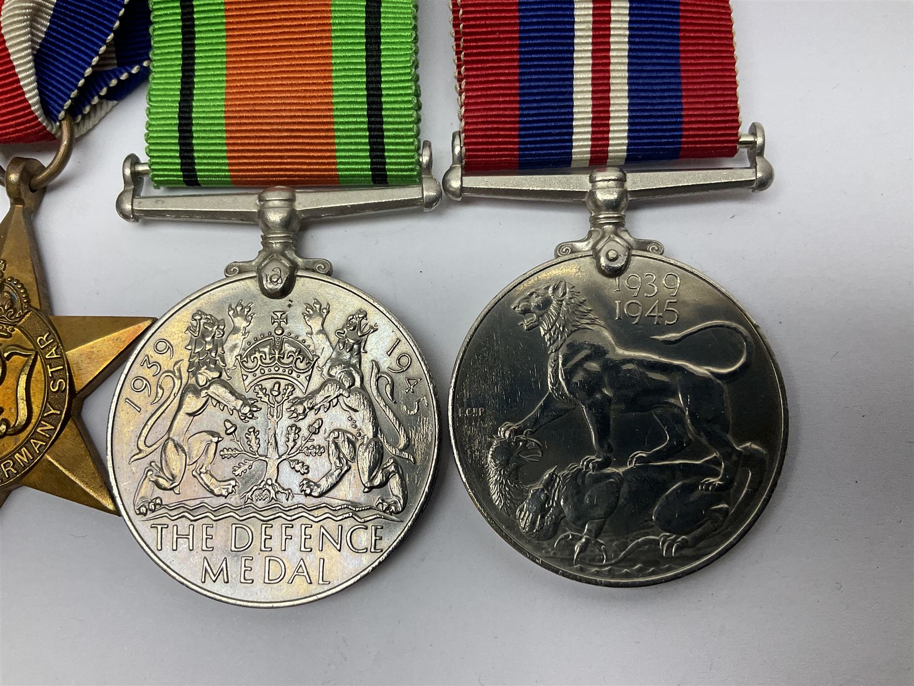 WWII group of five medals comprising 1939-45 War Medal, Defence Medal, 1939-45 Star, Africa Star and France and Germany Star on wearing bar; WWI British War Medal awarded to 142019 Pte. A. Thompson A.S.C.; and boxed King's Badge 'For Loyal Service'