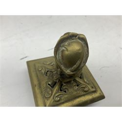 Collection of victorian and later brass desk accessories, to include a letter holder with cherub design, ink well of square form with hinged lid, brass table bell, brass casket with relief decoration, etc  