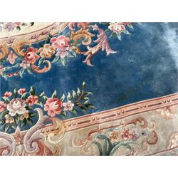 Large Chinese blue ground woollen carpet, overall floral design, central oval medallion surrounded by scrolling floral decoration, wide border with decorated with floral bouquets 