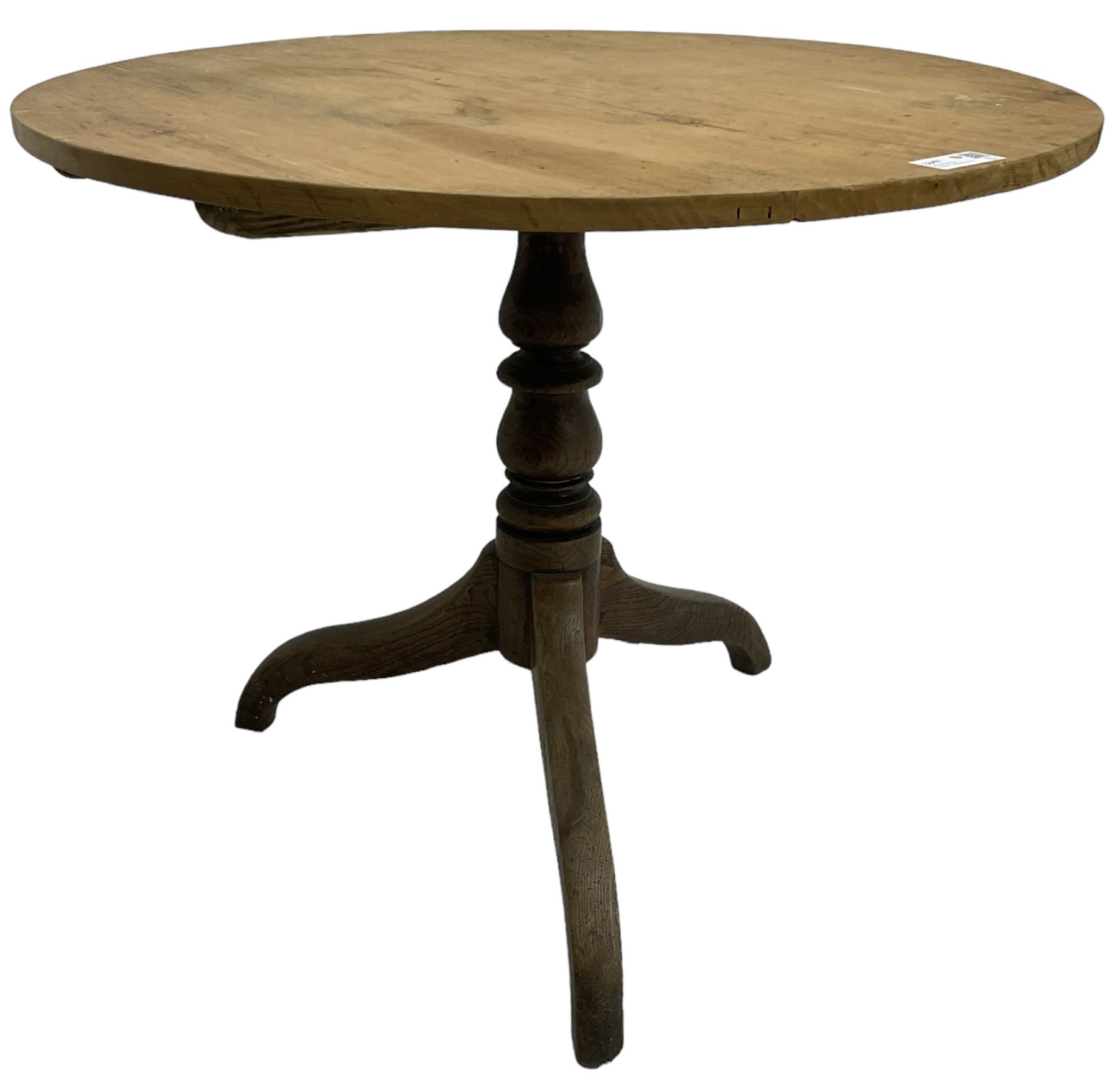 Early 19th century pine and elm tripod table; circular tilt-top over turned column and three splayed supports