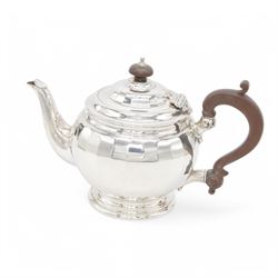 1920s silver teapot, of spherical faceted form, with Bakelite type handle and finial, upon...